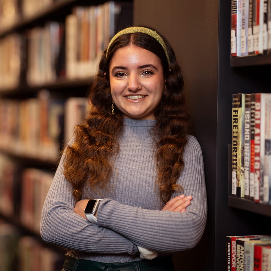 Portrait of a Pioneer alumna in a Princeton library