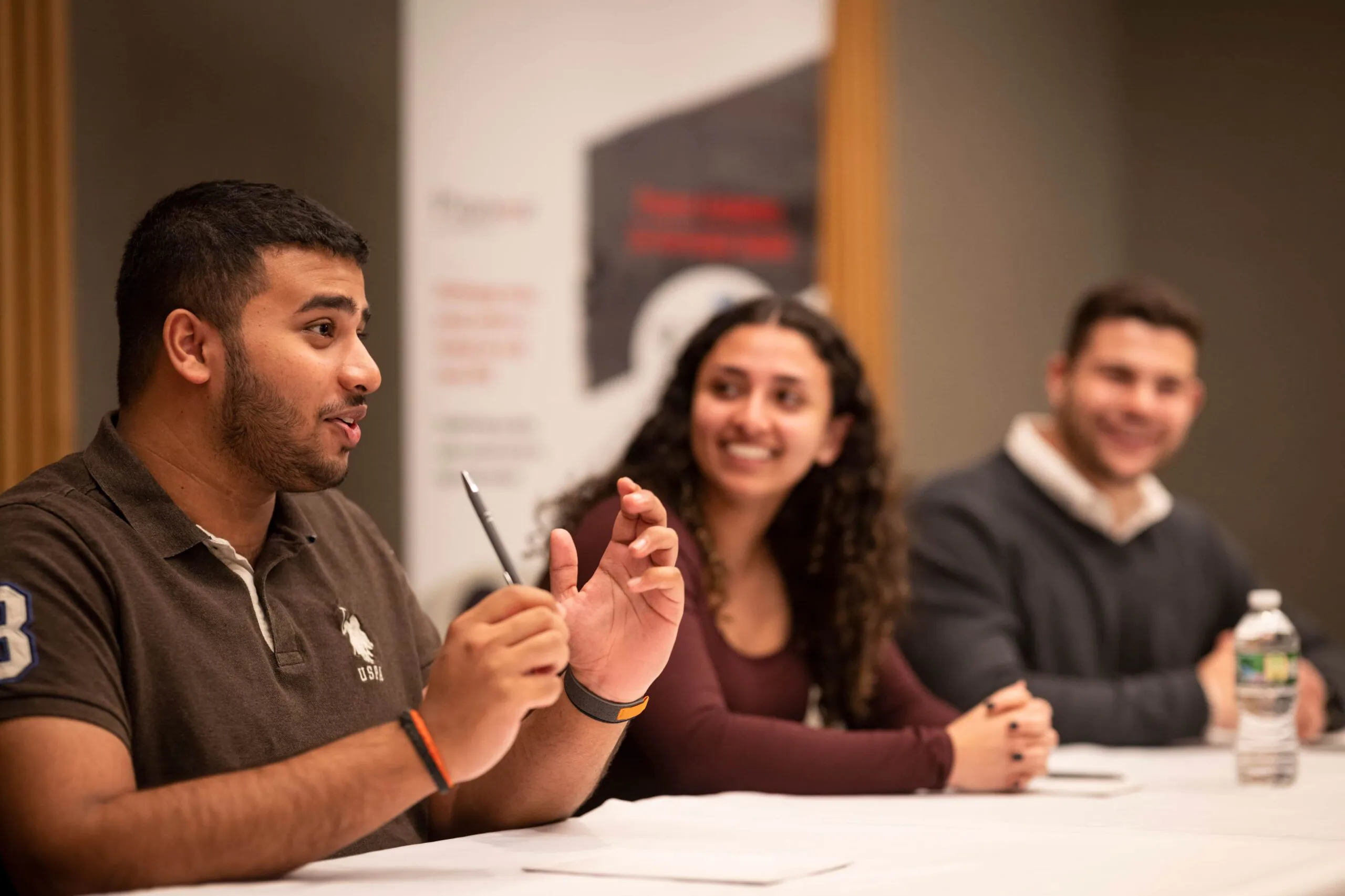Three Pioneer alumni speaking at a panel discussion at the University of Pennsylvania.