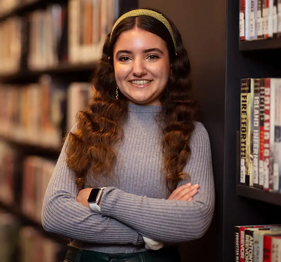 Portrait of a Pioneer alumna in a Princeton library