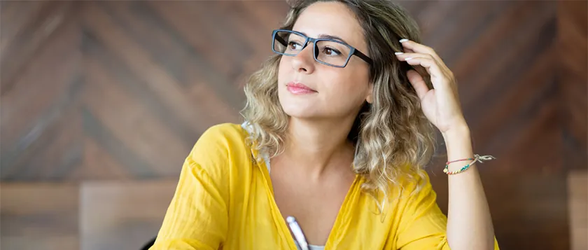 woman thinking and writing down ideas